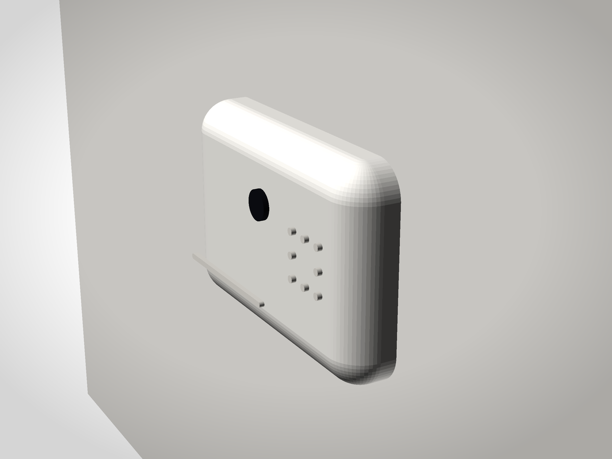 Ghost on a wall by daylight: white slab with a small dark eye and a vent dot grid